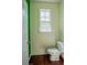 Bathroom with toilet and sink, hardwood floors and green and white walls at 743 Pecan Knoll Dr # 5, Marietta, GA 30008