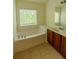 The bathroom features tile floors, a soaking tub and vanity with storage at 743 Pecan Knoll Dr # 5, Marietta, GA 30008