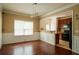 Dining room showcasing wood floors, wainscoting, and an open view into the kitchen at 743 Pecan Knoll Dr # 5, Marietta, GA 30008