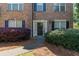 Inviting townhouse entrance with mature landscaping, pine straw and dark shutters at 743 Pecan Knoll Dr # 5, Marietta, GA 30008