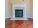 Fireplace featuring a white mantel and neutral tile surround, above hardwood floors at 743 Pecan Knoll Dr # 5, Marietta, GA 30008