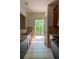 View of kitchen featuring granite counters, dark cabinets, tile floors, and deck access at 743 Pecan Knoll Dr # 5, Marietta, GA 30008