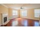 Spacious living room featuring hardwood floors, a fireplace with white mantle and large windows at 743 Pecan Knoll Dr # 5, Marietta, GA 30008