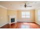 Spacious living room featuring hardwood floors, a fireplace with white mantle and a ceiling fan at 743 Pecan Knoll Dr # 5, Marietta, GA 30008