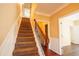 Carpeted staircase featuring hardwood flooring, white trim and wood and iron railings at 743 Pecan Knoll Dr # 5, Marietta, GA 30008