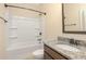Bathroom showcasing a granite sink, built-in storage, and a shower and tub at 23 Oxford Ln, Kingston, GA 30145