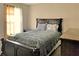 Bedroom showcasing a decorative dark-wood bed frame, side tables, and natural light at 23 Oxford Ln, Kingston, GA 30145