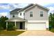 Charming two-story home featuring a gray exterior, attached garage, and well-maintained front yard at 23 Oxford Ln, Kingston, GA 30145