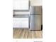 Modern kitchen featuring white cabinets, granite countertops, stainless steel refrigerator and luxury vinyl floors at 23 Oxford Ln, Kingston, GA 30145