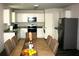 Eat-in kitchen area featuring a dining table, white cabinets, granite countertops, and stainless steel appliances at 23 Oxford Ln, Kingston, GA 30145