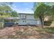 A view of the backyard and home's exterior, which features a partial hillside at 2352 S Hairston Rd, Decatur, GA 30035