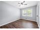 This bedroom features wood floors, a ceiling fan, and a bright window at 2352 S Hairston Rd, Decatur, GA 30035