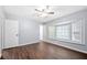 Bright bedroom featuring a ceiling fan, wood floors, and a cozy bay window with natural light at 2352 S Hairston Rd, Decatur, GA 30035