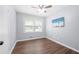 This bedroom features wood floors, a ceiling fan, and a bright window at 2352 S Hairston Rd, Decatur, GA 30035