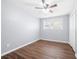A bedroom with wood-look floors, a ceiling fan, a closet, and a window that provides natural light at 2352 S Hairston Rd, Decatur, GA 30035