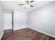 This bedroom features wood floors, a ceiling fan, and a bright window at 2352 S Hairston Rd, Decatur, GA 30035
