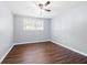 A bedroom with wood-look floors, a ceiling fan, and a window, creating a relaxing atmosphere at 2352 S Hairston Rd, Decatur, GA 30035