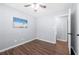 This bedroom features wood floors, a ceiling fan, and a bright window at 2352 S Hairston Rd, Decatur, GA 30035