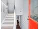 Inviting entryway features a vibrant red door and staircase with white banisters at 2352 S Hairston Rd, Decatur, GA 30035