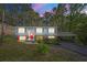 Charming home with a bright red door, carport, and well-maintained landscaping at 2352 S Hairston Rd, Decatur, GA 30035