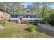 Well-maintained home with a red door, covered parking, and mature landscaping at 2352 S Hairston Rd, Decatur, GA 30035
