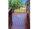 The cozy, stained back deck overlooks a spacious, green backyard at 2512 Montezuma Cir, Ellenwood, GA 30294
