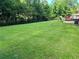 Lush green backyard surrounded by trees, creating a private outdoor oasis at 2512 Montezuma Cir, Ellenwood, GA 30294