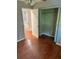 Bedroom with wood floors and a closet, offering functional space at 2512 Montezuma Cir, Ellenwood, GA 30294
