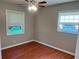 Bedroom featuring hardwood floors, neutral paint, a ceiling fan, and a window at 2512 Montezuma Cir, Ellenwood, GA 30294