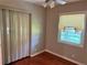 Bedroom featuring hardwood floors, neutral paint, a closet and window at 2512 Montezuma Cir, Ellenwood, GA 30294