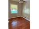 This bedroom offers hardwood floors, neutral paint and a ceiling fan at 2512 Montezuma Cir, Ellenwood, GA 30294