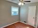 Bedroom featuring hardwood floors, neutral paint, a ceiling fan, and a window at 2512 Montezuma Cir, Ellenwood, GA 30294