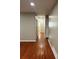 Hallway featuring hardwood floors connecting different areas of the home at 2512 Montezuma Cir, Ellenwood, GA 30294