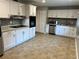Well-equipped kitchen with white cabinets, mosaic backsplash, and modern appliances at 2512 Montezuma Cir, Ellenwood, GA 30294
