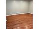 Spacious room featuring gleaming hardwood flooring and neutral paint at 2512 Montezuma Cir, Ellenwood, GA 30294
