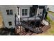 A multi-level deck is attached to a gray two-story home with an adjacent grass yard at 3228 Trinity Mill Cir, Dacula, GA 30019
