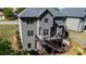 A multi-level wood deck is attached to a gray two-story home with an adjacent yard at 3228 Trinity Mill Cir, Dacula, GA 30019