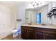 Bathroom featuring double sinks, dark wood cabinets, and shower-tub combination at 3228 Trinity Mill Cir, Dacula, GA 30019