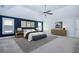 A stylish primary bedroom with a vaulted ceiling, three windows, and blue accent wall at 3228 Trinity Mill Cir, Dacula, GA 30019