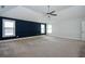 Spacious primary bedroom with blue accent wall, neutral carpet, and bright, natural light at 3228 Trinity Mill Cir, Dacula, GA 30019