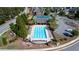 An aerial shot shows a community pool and tennis courts surrounded by trees and greenery at 3228 Trinity Mill Cir, Dacula, GA 30019