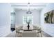 Dining room features a large window, a modern chandelier and seating for eight at 3228 Trinity Mill Cir, Dacula, GA 30019