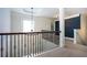 A hallway with carpet, white trim, and wrought iron spindles at 3228 Trinity Mill Cir, Dacula, GA 30019