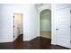 Hallway with hardwood floors, white wainscoting, and open doorways at 3228 Trinity Mill Cir, Dacula, GA 30019
