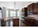 Modern kitchen with stainless steel appliances, dark cabinets, and granite countertops at 3228 Trinity Mill Cir, Dacula, GA 30019