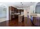Open-concept kitchen features dark wood cabinets, granite countertops, and stainless steel appliances at 3228 Trinity Mill Cir, Dacula, GA 30019