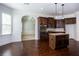 Spacious kitchen with dark wood cabinetry, stainless steel appliances, and granite countertops at 3228 Trinity Mill Cir, Dacula, GA 30019