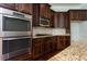 Close-up of the kitchen featuring stainless steel double oven, granite countertops and tile backsplash at 3228 Trinity Mill Cir, Dacula, GA 30019