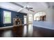 Open living room features a stone fireplace, backyard access, and view of the kitchen at 3228 Trinity Mill Cir, Dacula, GA 30019