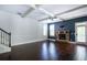 Open concept living room featuring hardwood floors and a stone fireplace at 3228 Trinity Mill Cir, Dacula, GA 30019
